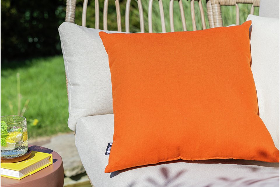 A Habitat terracotta outdoor cushion.